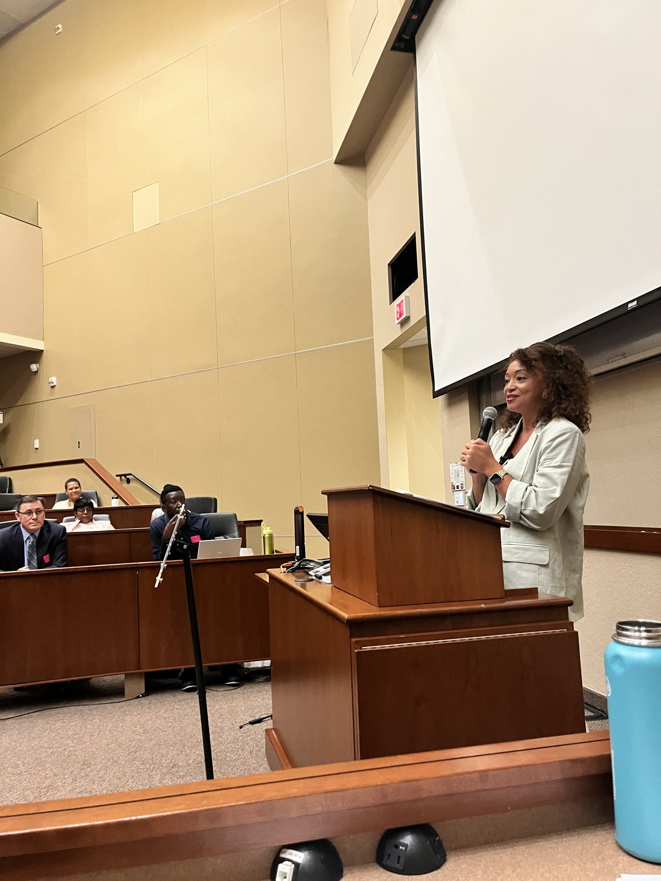Alivia Boddie speaking from a podium during a session in a lecture hall