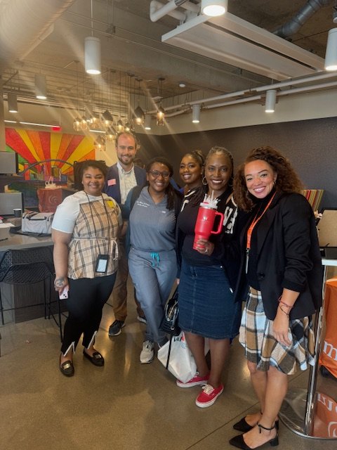 Alivia Boddie, at right, with a group of community members at an indoor event