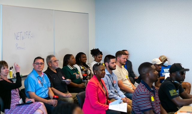 Participants seated in rows taking notes during a program session